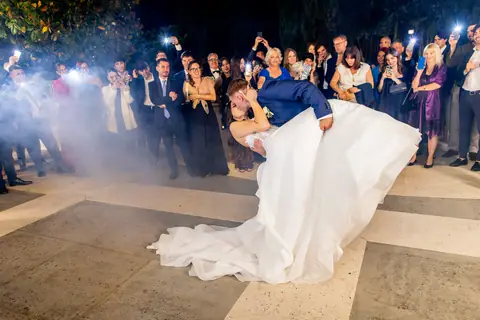 Gli sposi ballano avvolti dal fumo bianco tra gli invitati