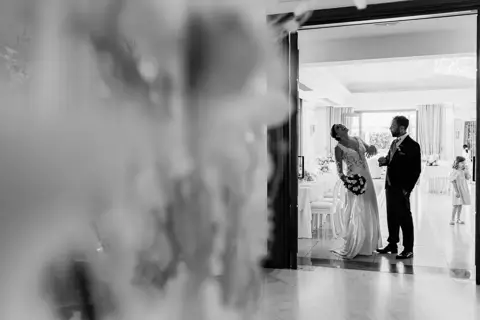 Gli sposi entrano in sala, riflesso in bianco e nero